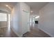 Bright hallway with light gray walls and wood-look flooring, leading to other rooms at 45 River Chapel Dr, Fuquay Varina, NC 27526