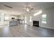 Spacious living room with hardwood floors, fireplace, and access to the kitchen at 45 River Chapel Dr, Fuquay Varina, NC 27526