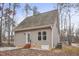 Tan house with a gabled roof, wood siding, and a small patio at 4716 Howe St, Durham, NC 27705