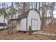 Charming outbuilding with concrete foundation and covered storage, nestled amongst the trees at 4716 Howe St, Durham, NC 27705