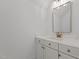 Bathroom vanity featuring white cabinets, marble countertop, and bronze fixtures at 4912 Hidden Pasture Way, Zebulon, NC 27597