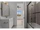Bathroom featuring a white vanity with gold fixtures, and a tiled shower/tub at 4912 Hidden Pasture Way, Zebulon, NC 27597