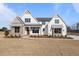 Striking two-story home with stone accents and a meticulously landscaped yard at 4912 Hidden Pasture Way, Zebulon, NC 27597