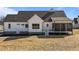 A stylish home showcasing a screened porch, white siding, and complementary dark roof accents at 4912 Hidden Pasture Way, Zebulon, NC 27597