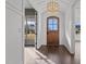 Inviting foyer with a wooden front door, chandelier, and dark hardwood floors at 4912 Hidden Pasture Way, Zebulon, NC 27597