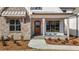 Charming front entrance featuring a wooden door and stone accents at 4912 Hidden Pasture Way, Zebulon, NC 27597