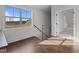 A well-lit hallway landing with hardwood floors, leading to other rooms at 4912 Hidden Pasture Way, Zebulon, NC 27597