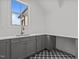 Laundry room featuring gray cabinets, a sink, countertops, and patterned floors at 4912 Hidden Pasture Way, Zebulon, NC 27597