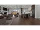 Open-concept living room connected to kitchen, with abundant natural light and coffered ceilings at 4912 Hidden Pasture Way, Zebulon, NC 27597