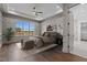 Spacious primary bedroom with a large window and paneled walls at 4912 Hidden Pasture Way, Zebulon, NC 27597
