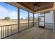 Screened porch with wood floor, ceiling fan, and a view of the landscape at 4912 Hidden Pasture Way, Zebulon, NC 27597