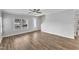 Neutral-toned living room featuring wood-look floors and lots of natural light at 510 Azalea Gaze Dr, Youngsville, NC 27596