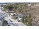 Aerial view of house with snow covered yard and trees at 520 Santa Gertrudis Dr, Clayton, NC 27520