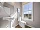Stylish powder room with pedestal sink and large window at 602 Market Grove Dr # 200, Wake Forest, NC 27587