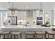 Modern kitchen with white cabinets, large island and stainless steel appliances at 602 Market Grove Dr # 200, Wake Forest, NC 27587