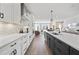 Open kitchen boasts white and dark cabinetry, quartz countertops, and stainless steel appliances at 604 Market Grove Dr # 200, Wake Forest, NC 27587