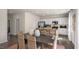 Open dining area with dark wood table, wicker chairs, and kitchen views at 6456 Alfalfa Ln, Wake Forest, NC 27587