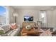 Bright living room with comfy seating, large TV, and natural light at 6456 Alfalfa Ln, Wake Forest, NC 27587