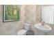 Stylish powder room with pedestal sink, toilet, and decorative wallpaper at 6456 Alfalfa Ln, Wake Forest, NC 27587