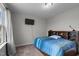 Bedroom with a blue striped bedspread and wall-mounted TV at 655 Hawksbill Dr, Franklinton, NC 27525