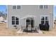 Backyard patio with seating, umbrella, and grill at 655 Hawksbill Dr, Franklinton, NC 27525
