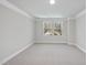 Spacious bedroom with neutral walls and carpet, and two windows at 7218 Sunrise Rd, Chapel Hill, NC 27514