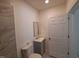 Clean bathroom with a toilet, vanity, and mirror at 723 S Washington St, Rocky Mount, NC 27801