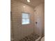 Updated bathroom with subway tile shower and pebble floor at 723 S Washington St, Rocky Mount, NC 27801