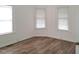 Spacious bedroom with wood flooring and multiple windows at 723 S Washington St, Rocky Mount, NC 27801