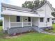 Charming white house with a porch, steps, and well-maintained lawn at 723 S Washington St, Rocky Mount, NC 27801