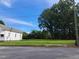 Vacant lot with large grassy area, mature trees, and nearby house at 723 S Washington St, Rocky Mount, NC 27801