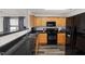 Modern kitchen featuring black appliances and wooden cabinets at 815 Plexor Ln, Knightdale, NC 27545