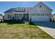 Charming single-story home featuring a well-manicured lawn and a two-car garage at 899 Olive Branch Dr, Smithfield, NC 27577