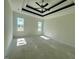 Serene main bedroom featuring a tray ceiling and plenty of natural light from the windows at 899 Olive Branch Dr, Smithfield, NC 27577