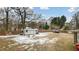 Large backyard with shed, boat, and partially snow covered grass at 927 Bellvue St, Burlington, NC 27217
