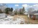 Large backyard with shed, boat, and partially snow covered grass at 927 Bellvue St, Burlington, NC 27217