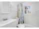 Clean bathroom with shower/tub combo, white vanity, and window at 927 Bellvue St, Burlington, NC 27217