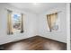 Simple bedroom with hardwood floors and two windows, ample natural light at 927 Bellvue St, Burlington, NC 27217