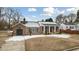 Brick ranch house with a covered porch and snowy yard at 927 Bellvue St, Burlington, NC 27217