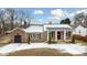 Brick ranch house with covered porch, landscaping, and a detached garage at 927 Bellvue St, Burlington, NC 27217