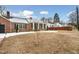 Brick house with a snow-covered lawn and walkway, showcasing curb appeal at 927 Bellvue St, Burlington, NC 27217