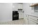 Kitchen with white cabinets, black stove, and mosaic backsplash at 927 Bellvue St, Burlington, NC 27217