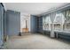 Living room with built-in shelving, carpet, and view into another room at 927 Bellvue St, Burlington, NC 27217