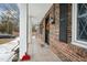 Brick house with a covered porch, showcasing an inviting entryway at 927 Bellvue St, Burlington, NC 27217