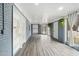 Sunroom with wood-look floors, gray brick walls, and large windows at 927 Bellvue St, Burlington, NC 27217