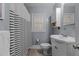 Clean bathroom with white vanity, striped shower curtain, and updated fixtures at 100 Forestwood Dr, Durham, NC 27707