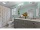 Modern bathroom with gray cabinets, marble countertops, and a walk-in shower at 100 Forestwood Dr, Durham, NC 27707