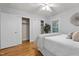 Comfortable bedroom featuring hardwood floors, large closets, and a ceiling fan at 100 Forestwood Dr, Durham, NC 27707