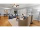 Bright living room with hardwood floors, neutral walls, and a partial view to dining room at 100 Forestwood Dr, Durham, NC 27707