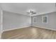 Spacious bedroom with ample natural light, ceiling fan, and wood-look flooring at 1006 Sedwick W Rd, Durham, NC 27713